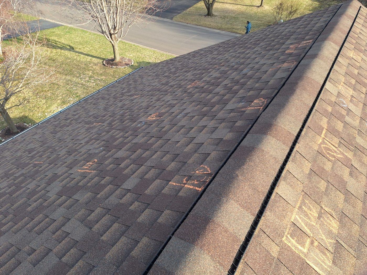 Live viewfinder on a shingle roof with chalk test squares during a hail inspection